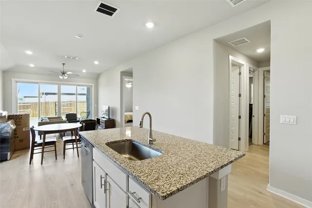 a kitchen with a table chairs microwave and cabinets