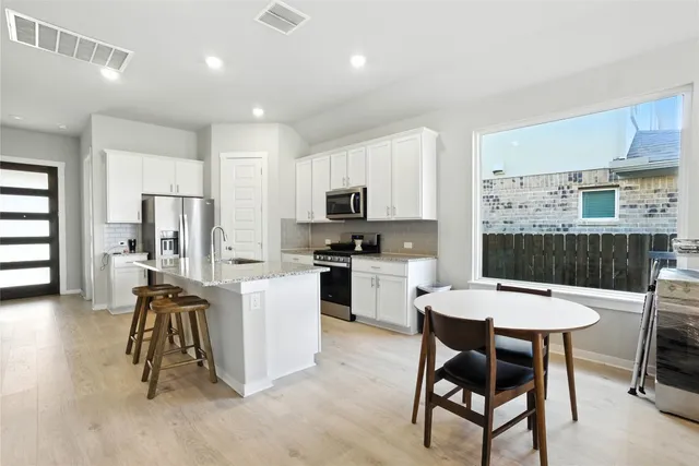 a living room with furniture and kitchen view