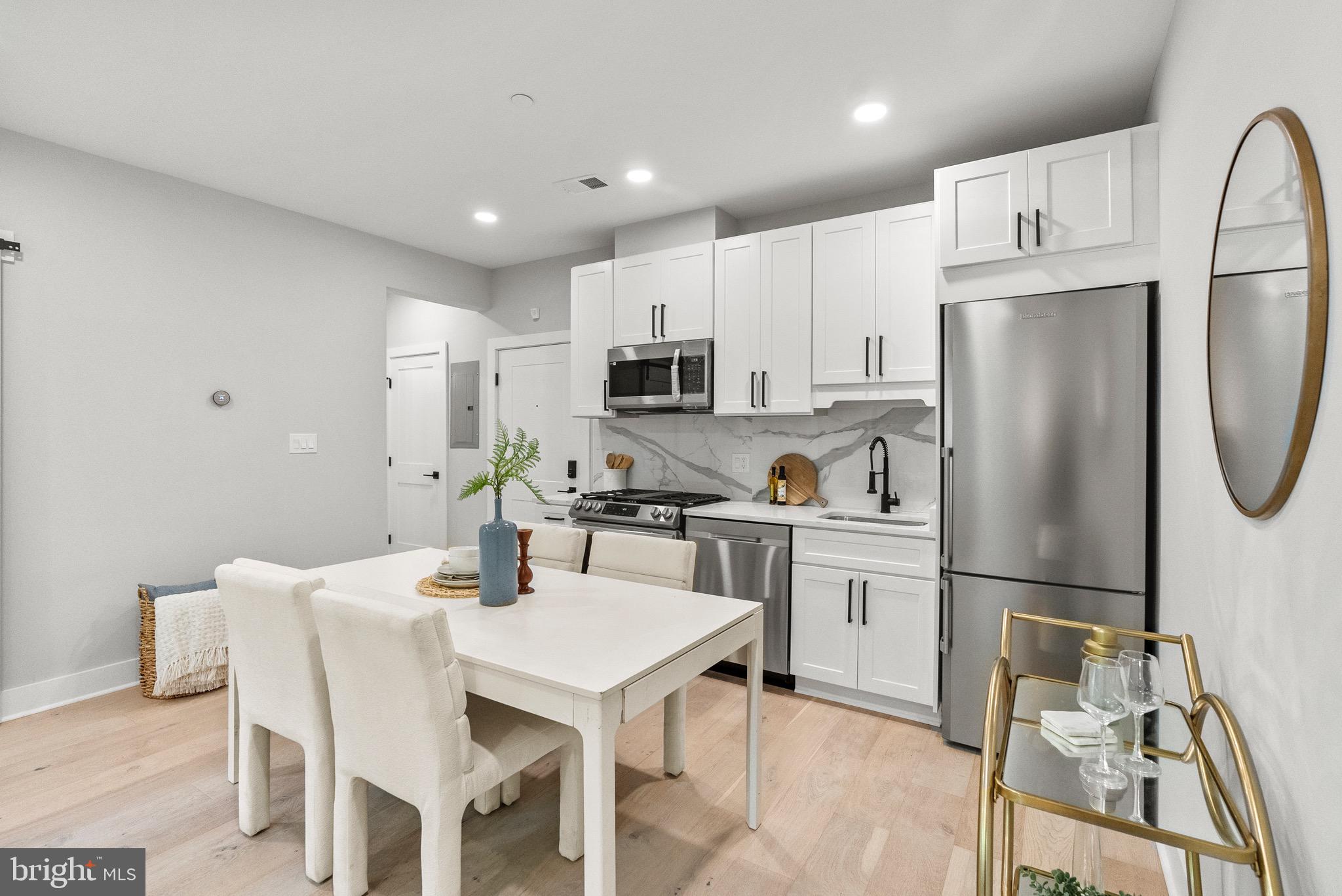 2019 M Street Northeast, Unit 1 Washington, DC 20002 - Photo 3 of 31 a kitchen with stainless steel appliances a refrigerator stove microwave and cabinets