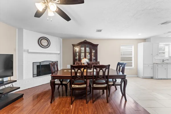 a view of a a dining room with furniture window and wooden floor
