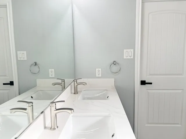 a bathroom with a tub sink and mirror