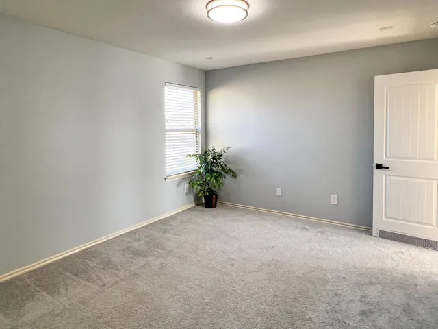 an empty room with windows and closet