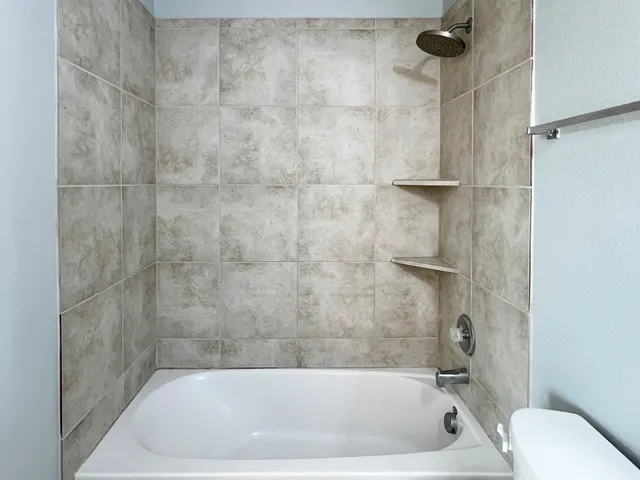 a bath tub sitting next to a white sink