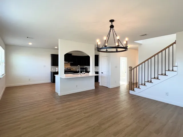 a view of kitchen and hall with wooden floor