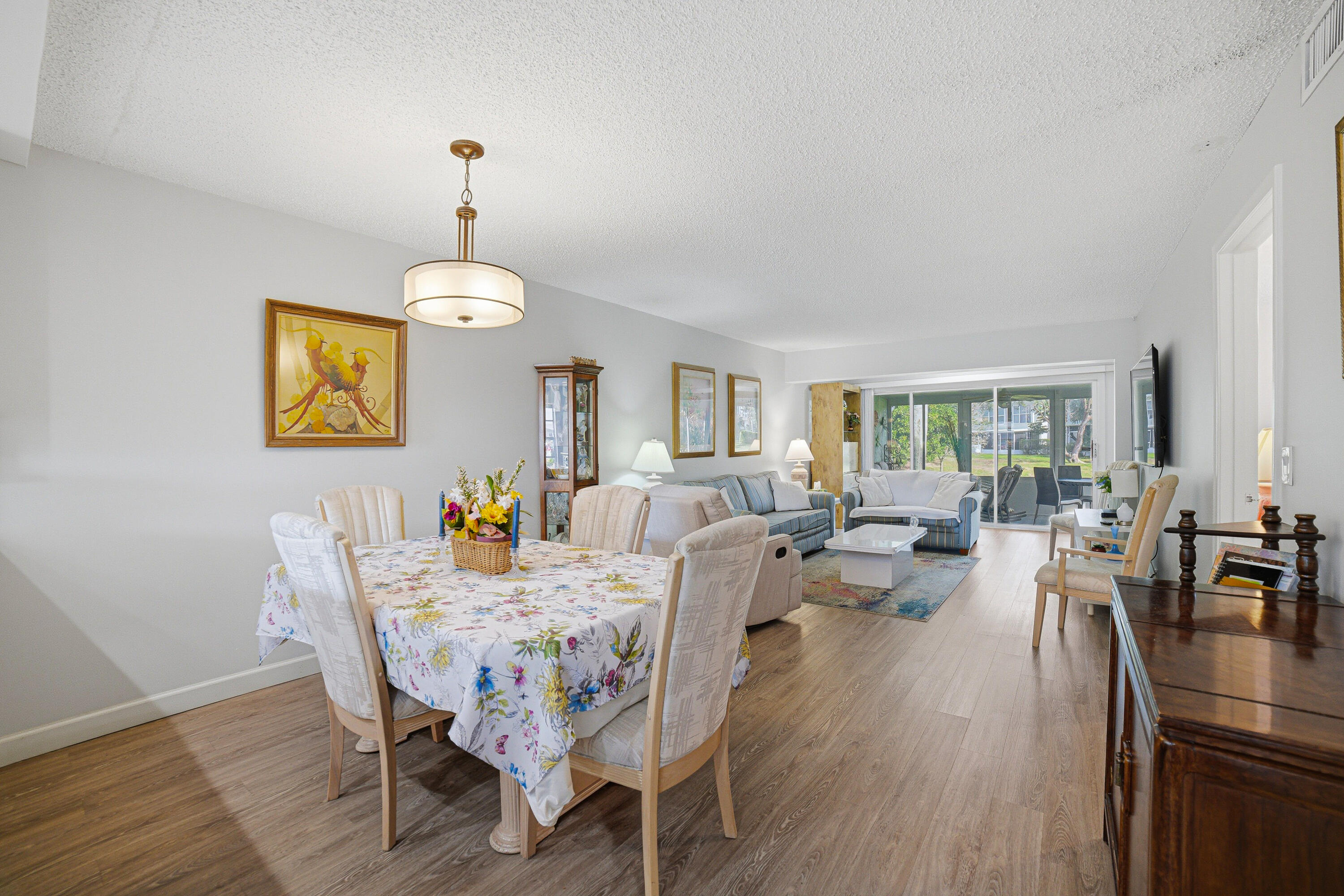 2901 Southwest 15th Street, Unit 102 Delray Beach, FL 33445 - Photo 11 of 59 a view of a dining room with furniture window and wooden floor