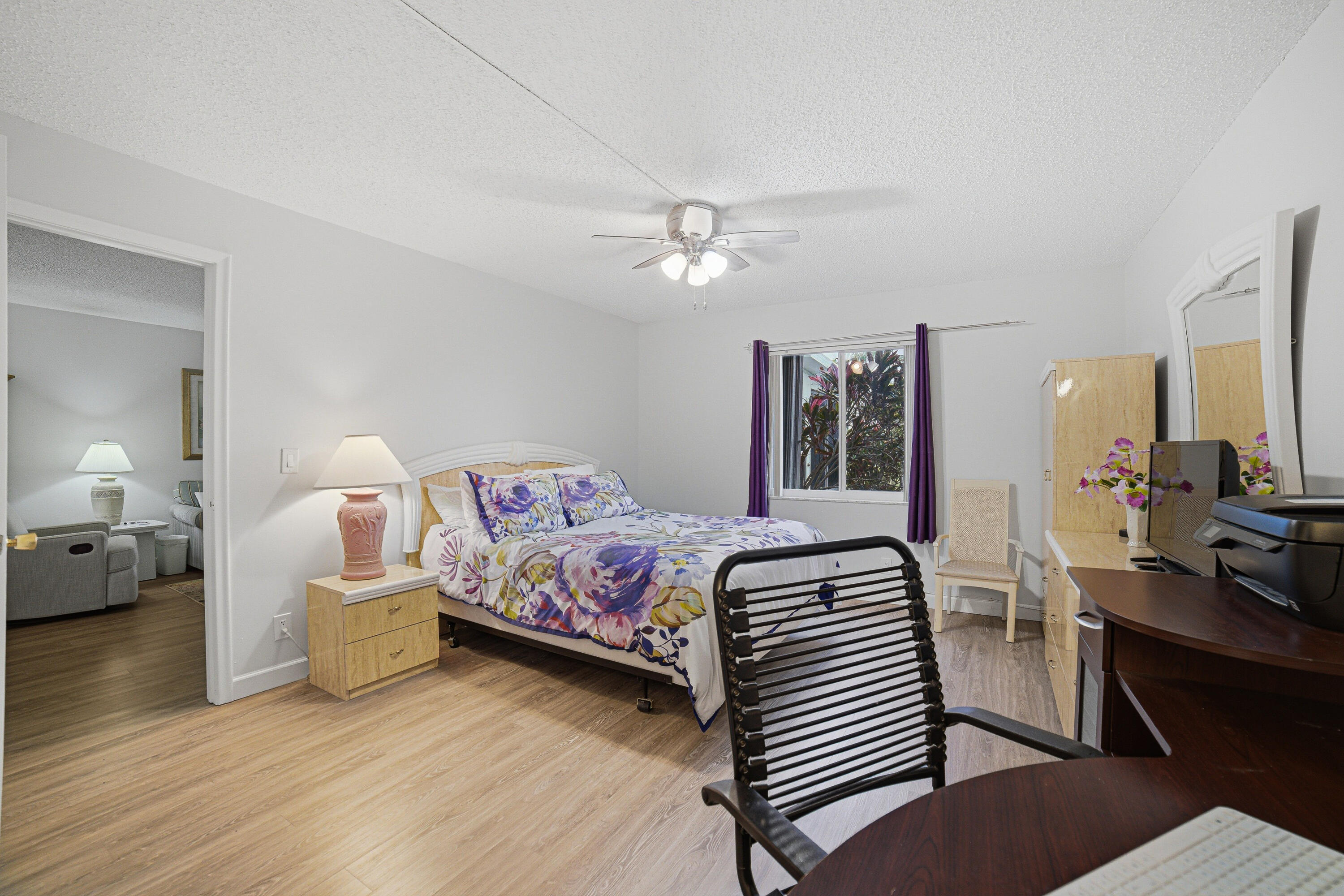 2901 Southwest 15th Street, Unit 102 Delray Beach, FL 33445 - Photo 16 of 59 a bedroom with a bed and wooden floor