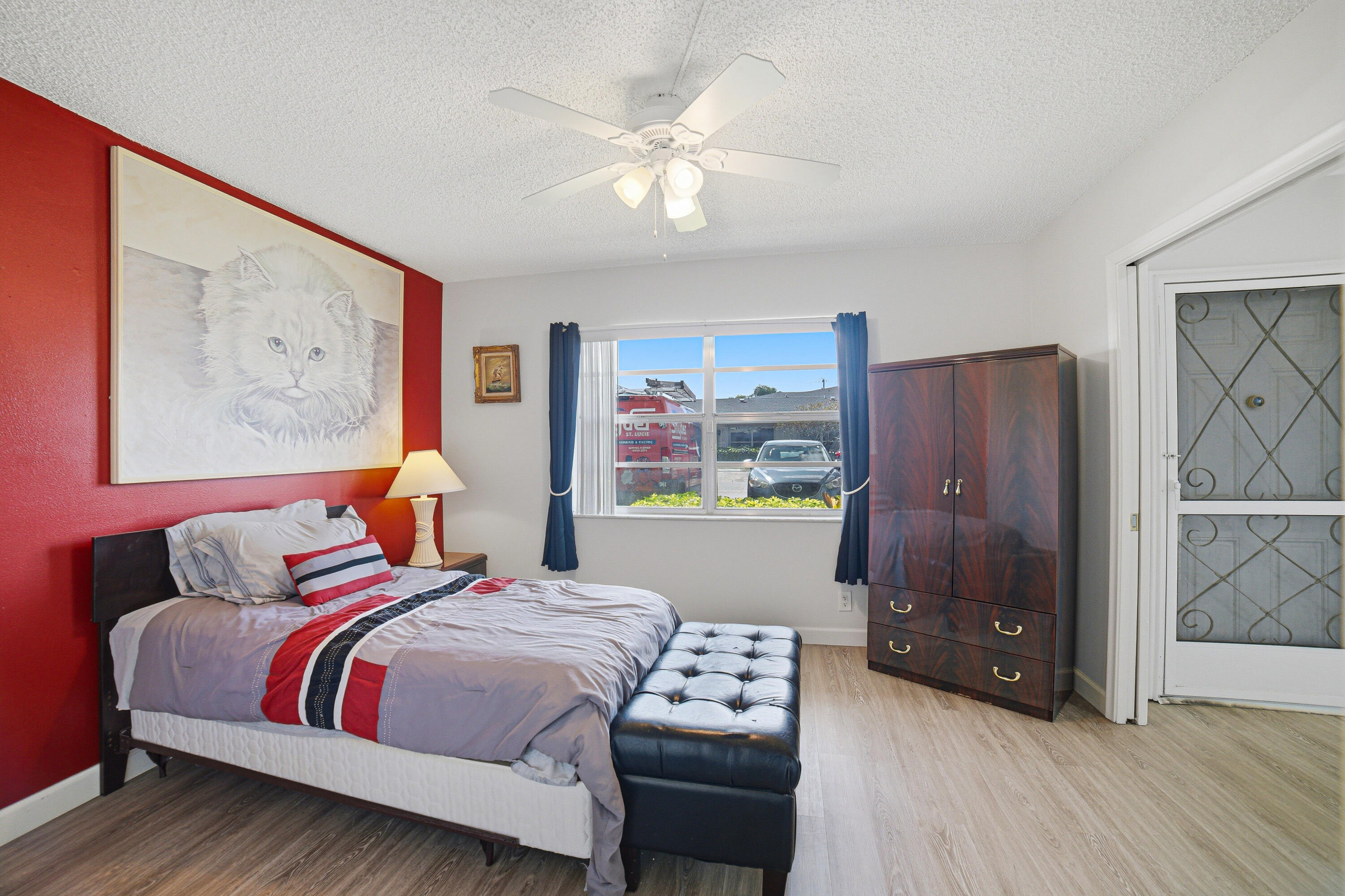 2901 Southwest 15th Street, Unit 102 Delray Beach, FL 33445 - Photo 20 of 59 a bedroom with a bed and a painting on the wall