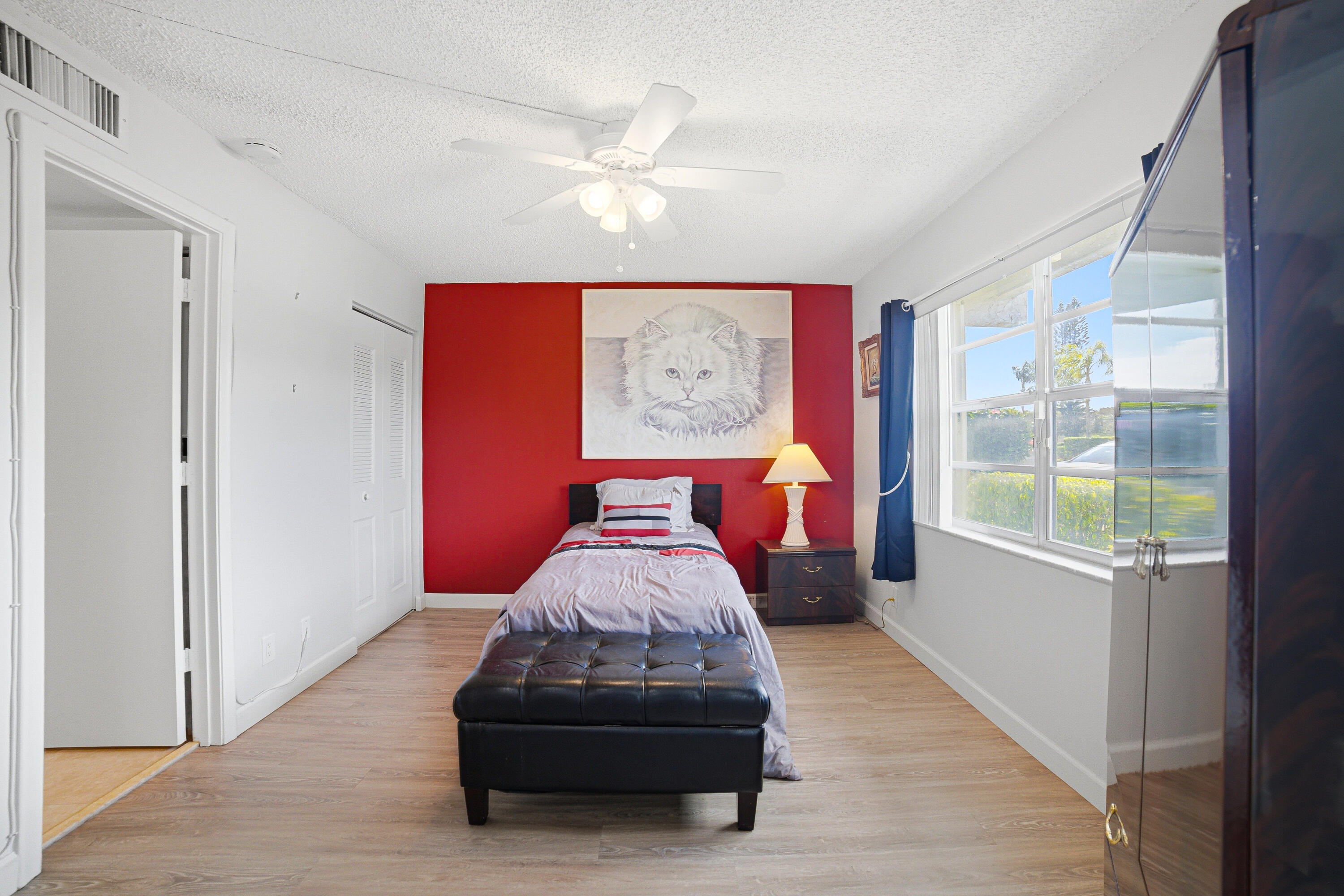 2901 Southwest 15th Street, Unit 102 Delray Beach, FL 33445 - Photo 21 of 59 a bedroom with furniture and a large window