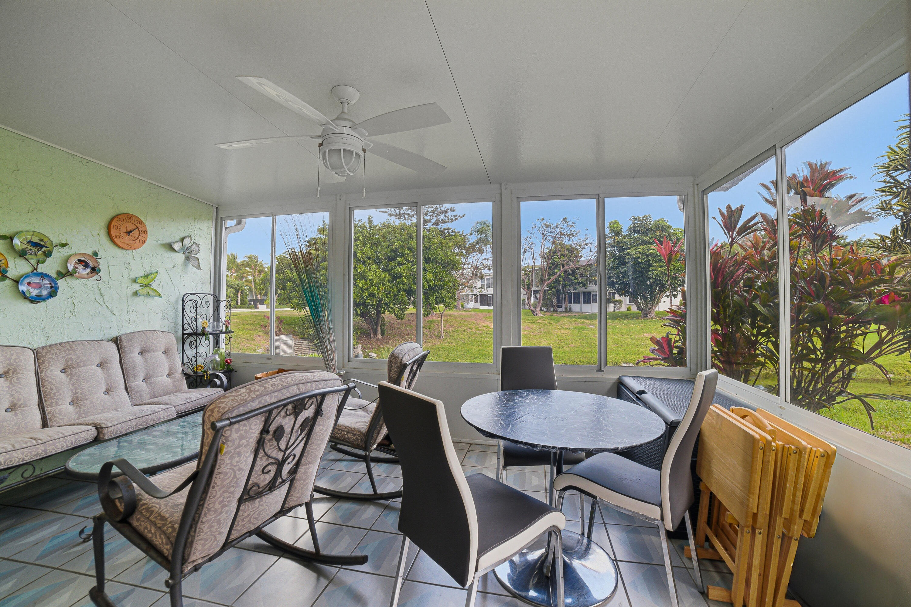 2901 Southwest 15th Street, Unit 102 Delray Beach, FL 33445 - Photo 24 of 59 a view of a dining room with furniture large windows and wooden floor