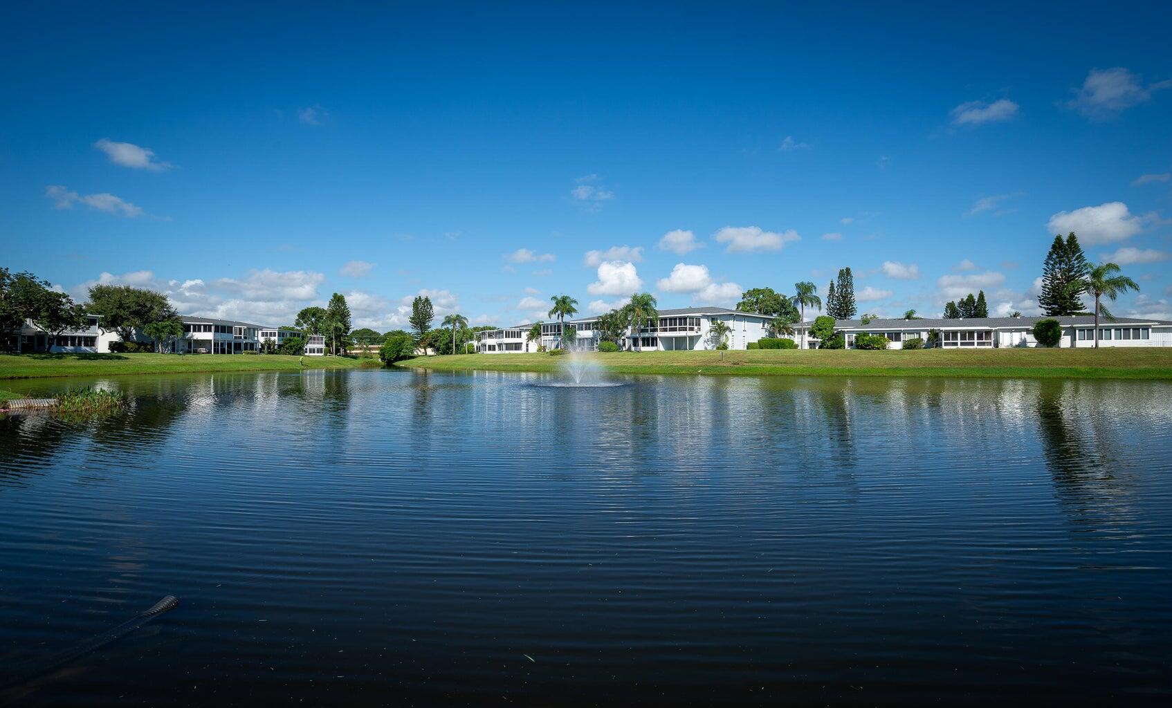 2901 Southwest 15th Street, Unit 102 Delray Beach, FL 33445 - Photo 30 of 59 a view of a lake with houses in the background