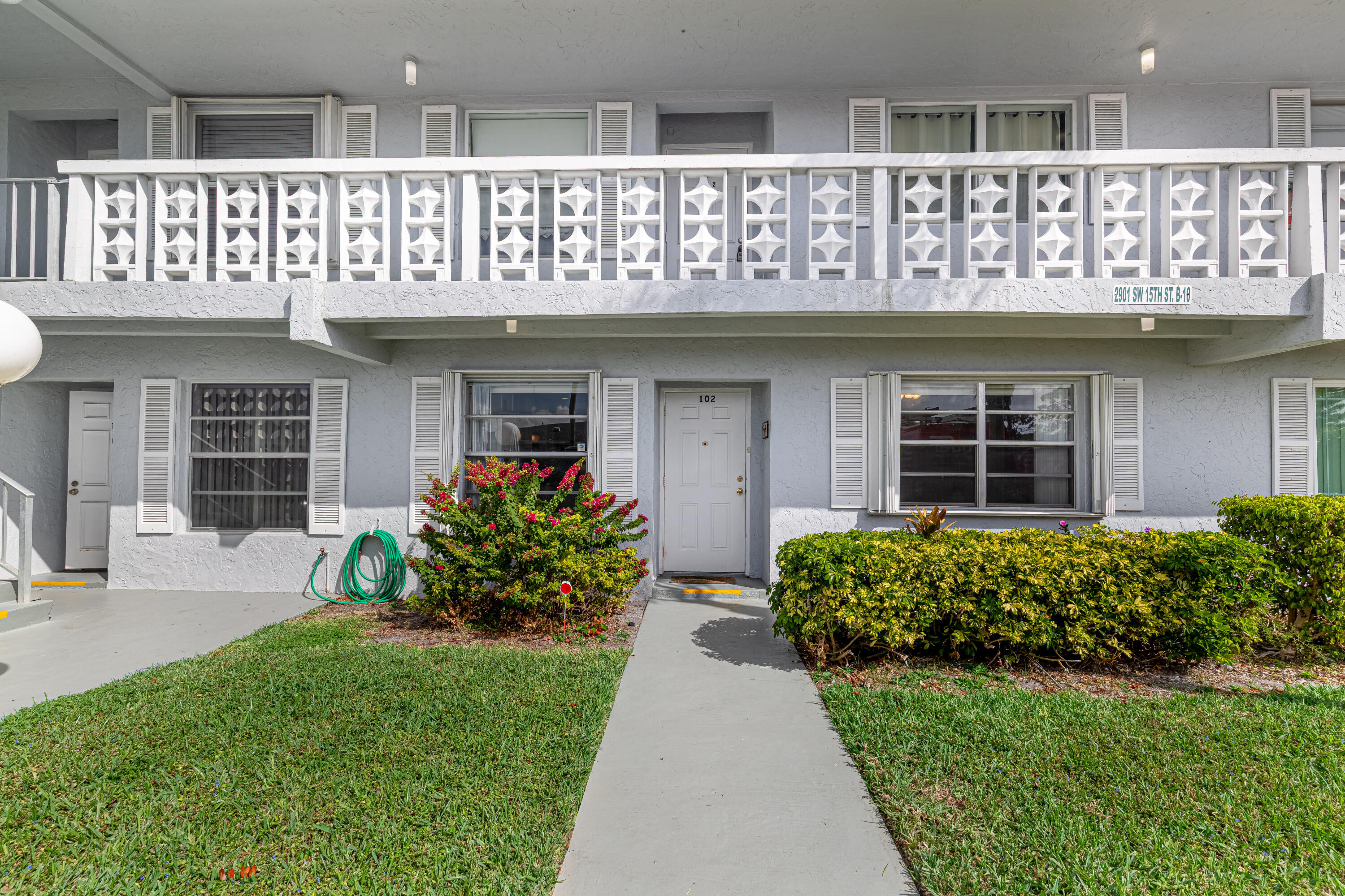 2901 Southwest 15th Street, Unit 102 Delray Beach, FL 33445 - Photo 4 of 59 a front view of a house with garden