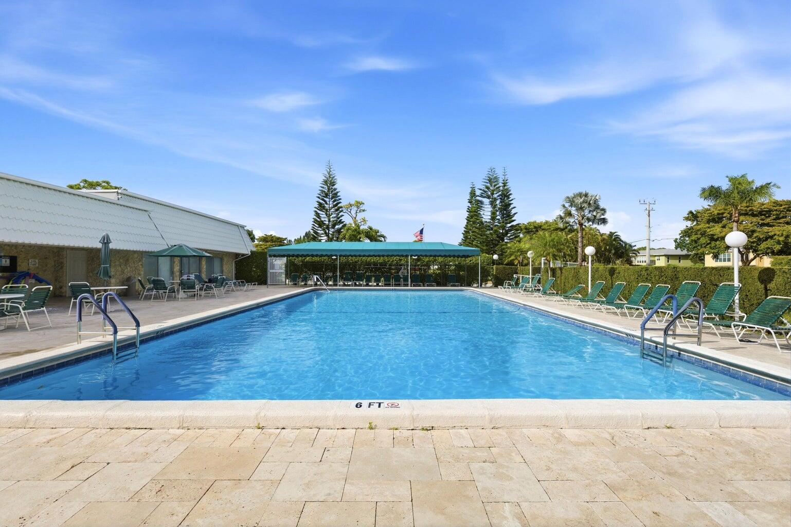 2901 Southwest 15th Street, Unit 102 Delray Beach, FL 33445 - Photo 41 of 59 a view of swimming pool with outdoor seating and wooden floor