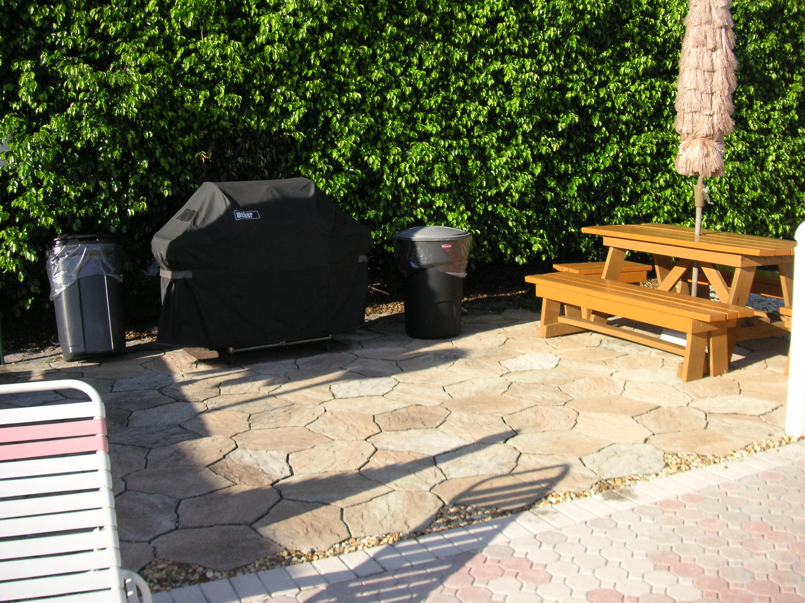 2901 Southwest 15th Street, Unit 102 Delray Beach, FL 33445 - Photo 47 of 59 a backyard of a house with yard and outdoor seating