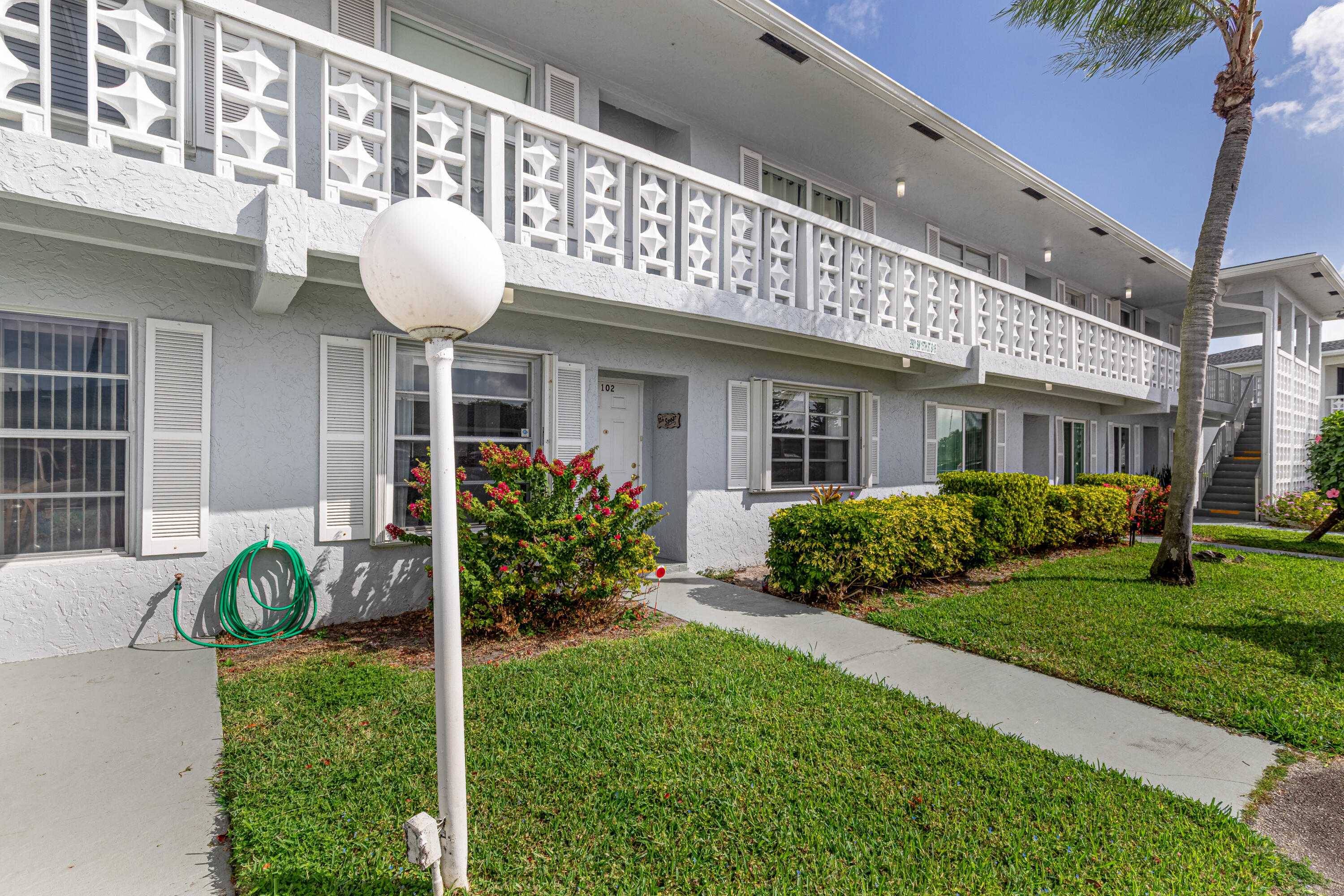 2901 Southwest 15th Street, Unit 102 Delray Beach, FL 33445 - Photo 5 of 59 a front view of a house with garden