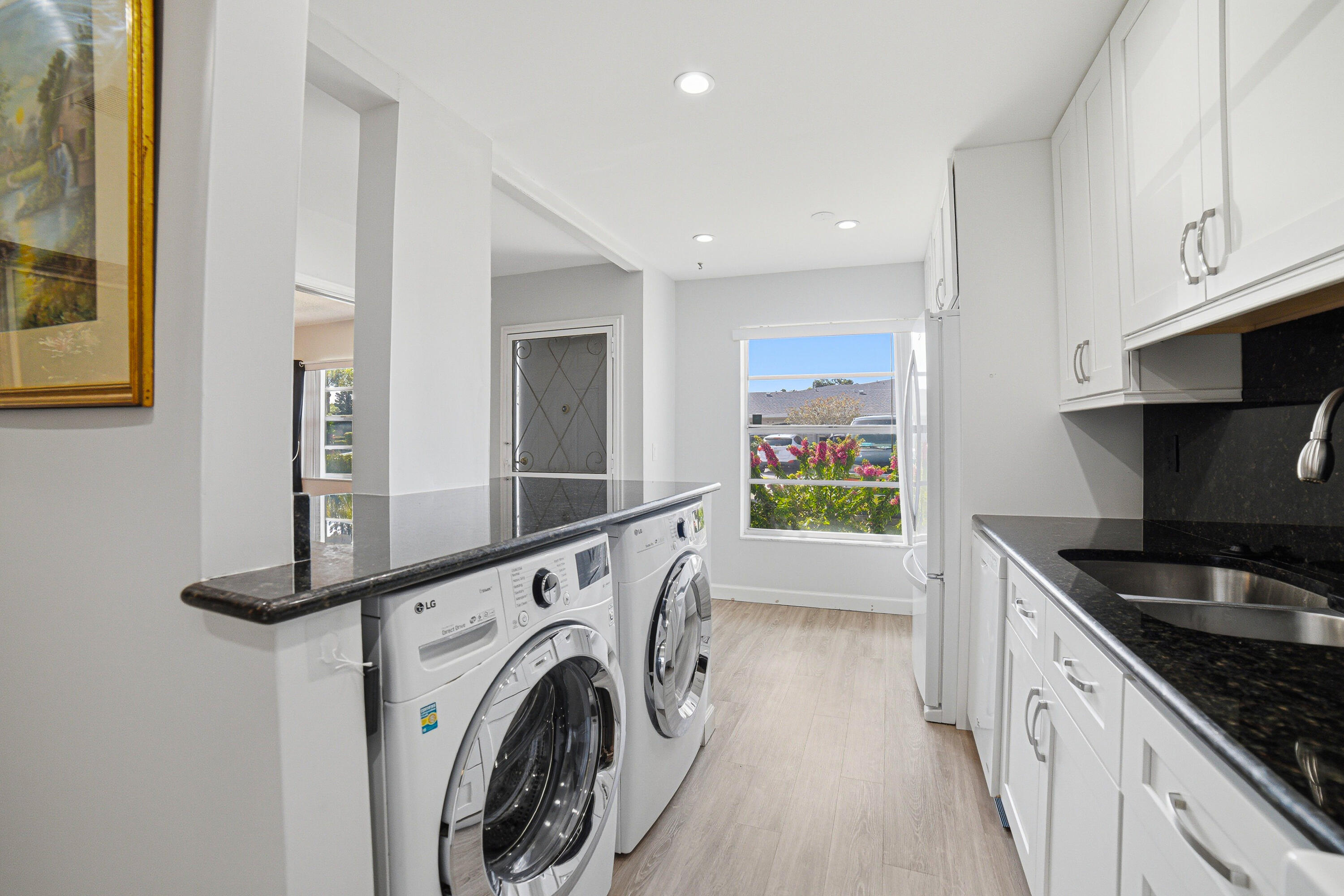 2901 Southwest 15th Street, Unit 102 Delray Beach, FL 33445 - Photo 8 of 59 a view of kitchen and washer and dryer
