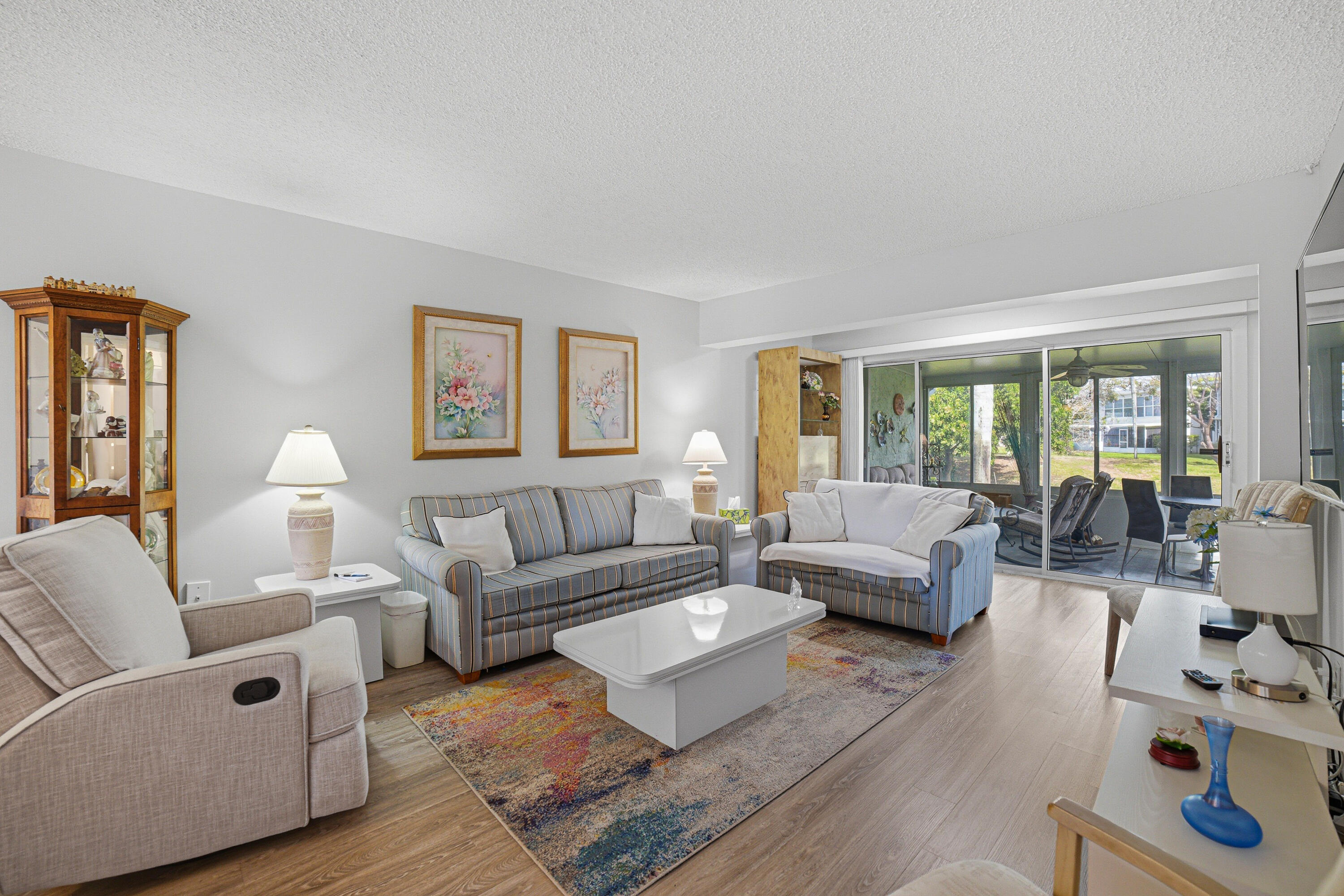 2901 Southwest 15th Street, Unit 102 Delray Beach, FL 33445 - Photo 9 of 59 a living room with furniture and a large window