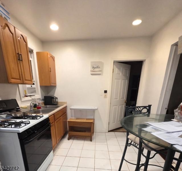 93 Raymond Avenue Plainfield, NJ 07062 - Photo 2 of 3 a kitchen with a stove a sink and a refrigerator