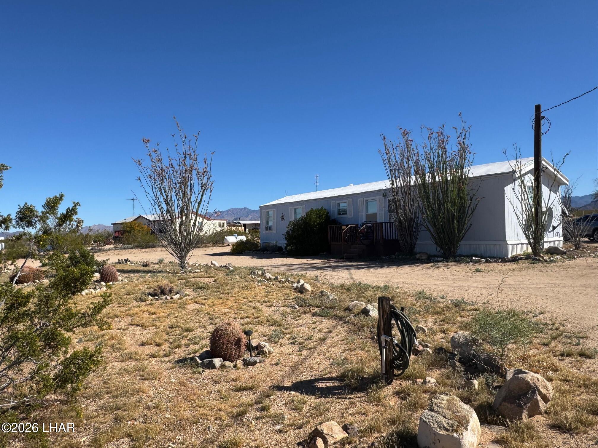 15454 Mohave Road Yucca, AZ 86438 - Photo 1 of 47 a view of a backyard of the house