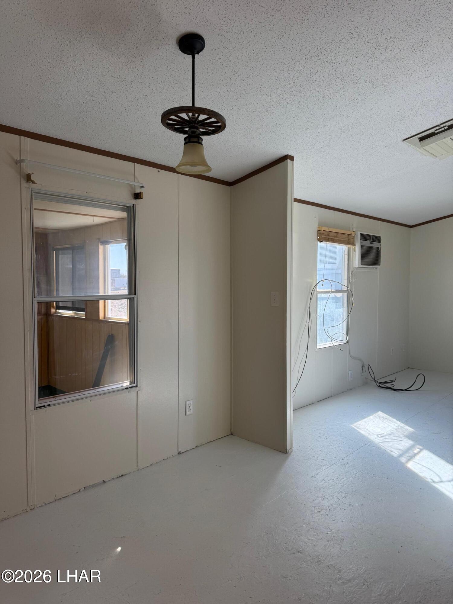 15454 Mohave Road Yucca, AZ 86438 - Photo 11 of 47 a view of empty room with windows and fan