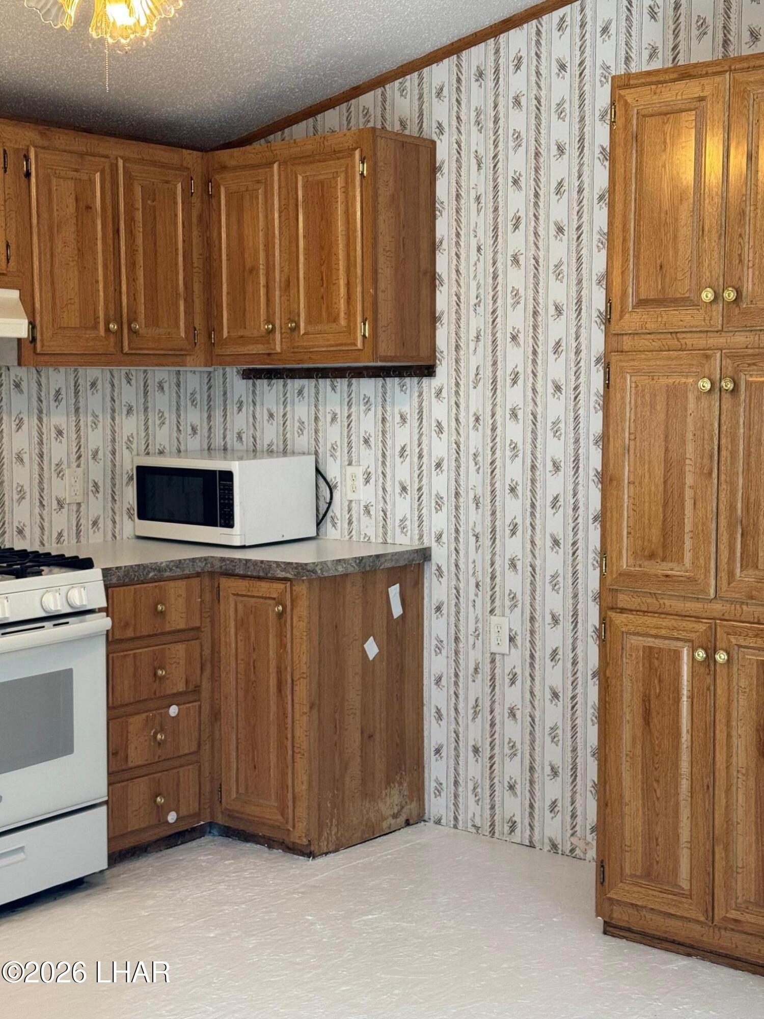 15454 Mohave Road Yucca, AZ 86438 - Photo 15 of 47 a kitchen with stainless steel appliances granite countertop a refrigerator and cabinets