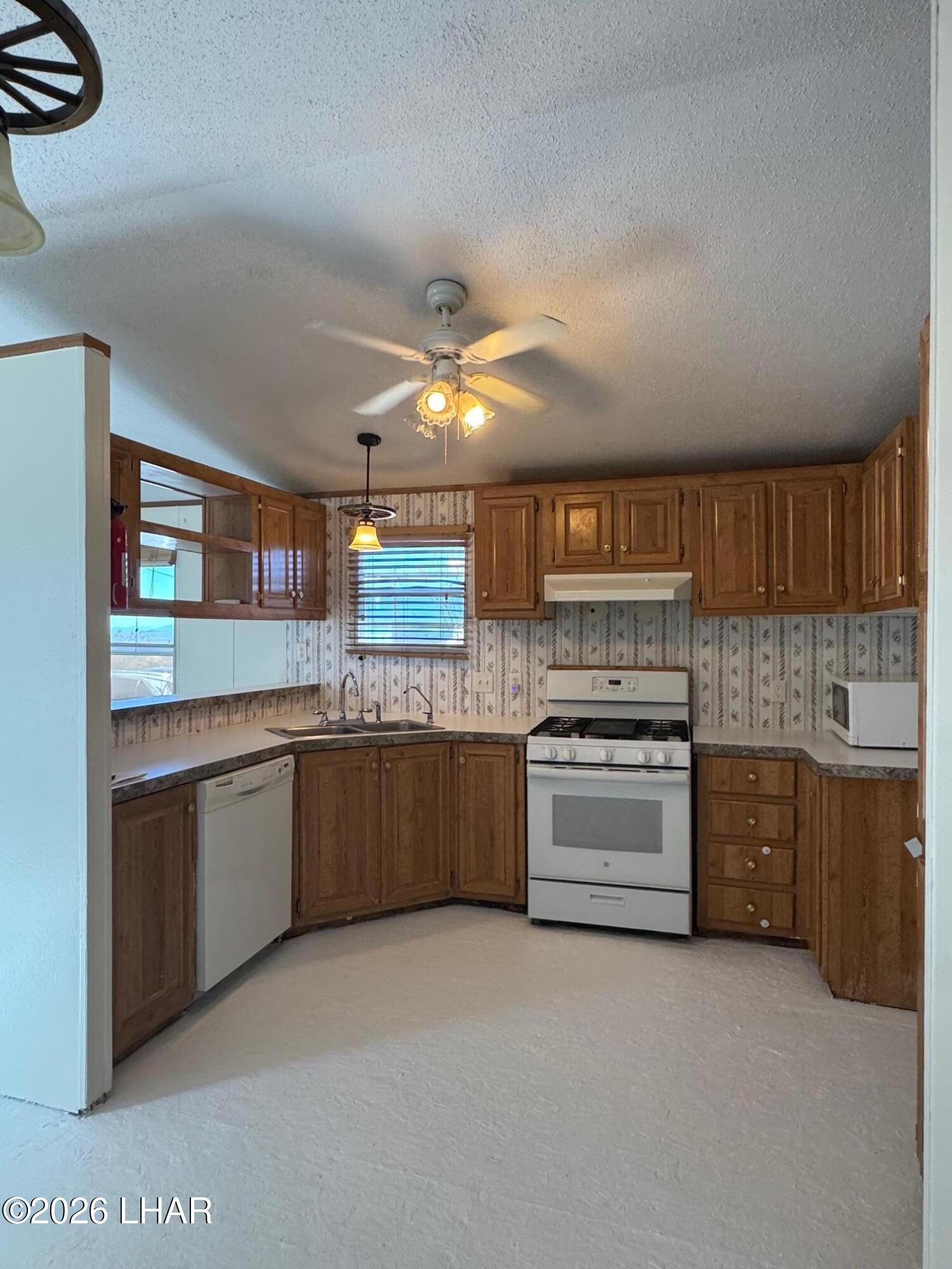 15454 Mohave Road Yucca, AZ 86438 - Photo 16 of 47 a large kitchen with a stove top oven
