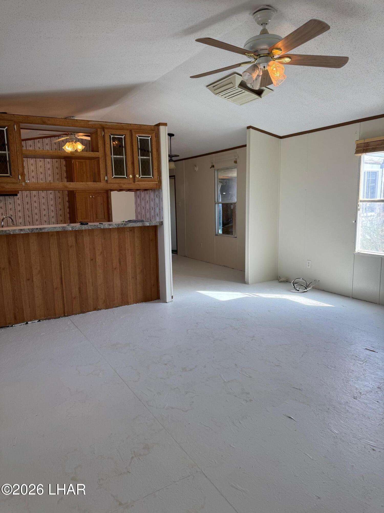 15454 Mohave Road Yucca, AZ 86438 - Photo 19 of 47 a view of a livingroom with a ceiling fan and window