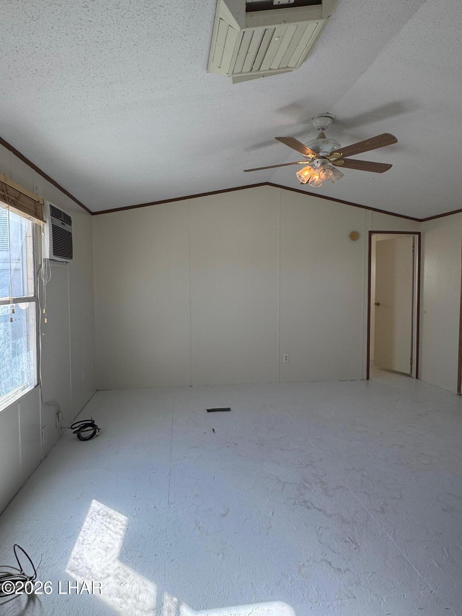 15454 Mohave Road Yucca, AZ 86438 - Photo 20 of 47 an empty room with windows