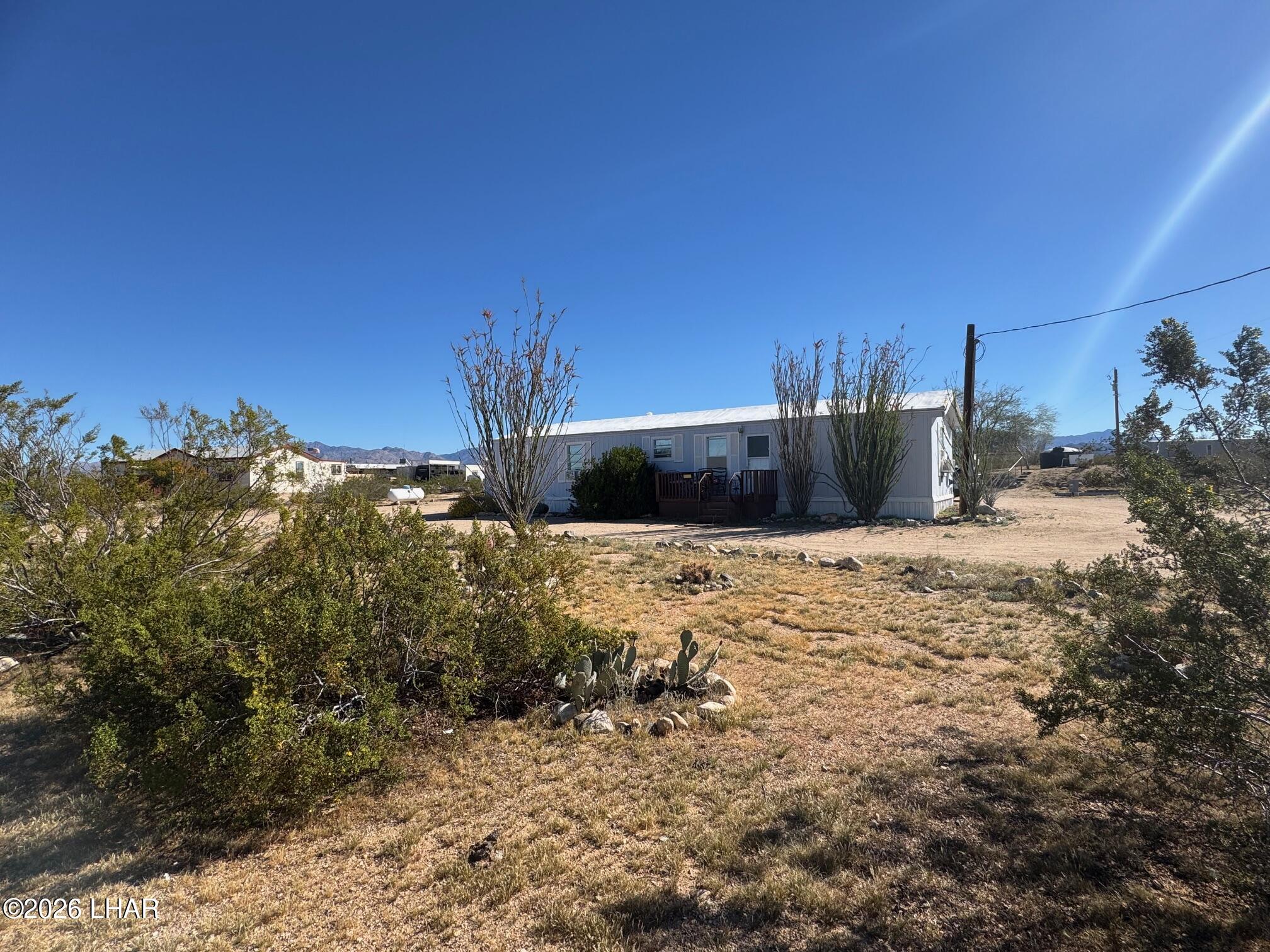 15454 Mohave Road Yucca, AZ 86438 - Photo 2 of 47 a large tree in the middle of a yard