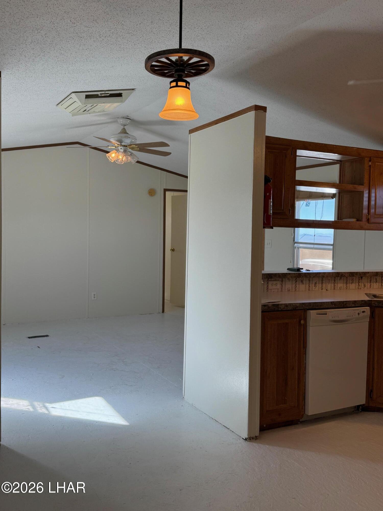 15454 Mohave Road Yucca, AZ 86438 - Photo 22 of 47 a kitchen with a refrigerator and a stove top oven