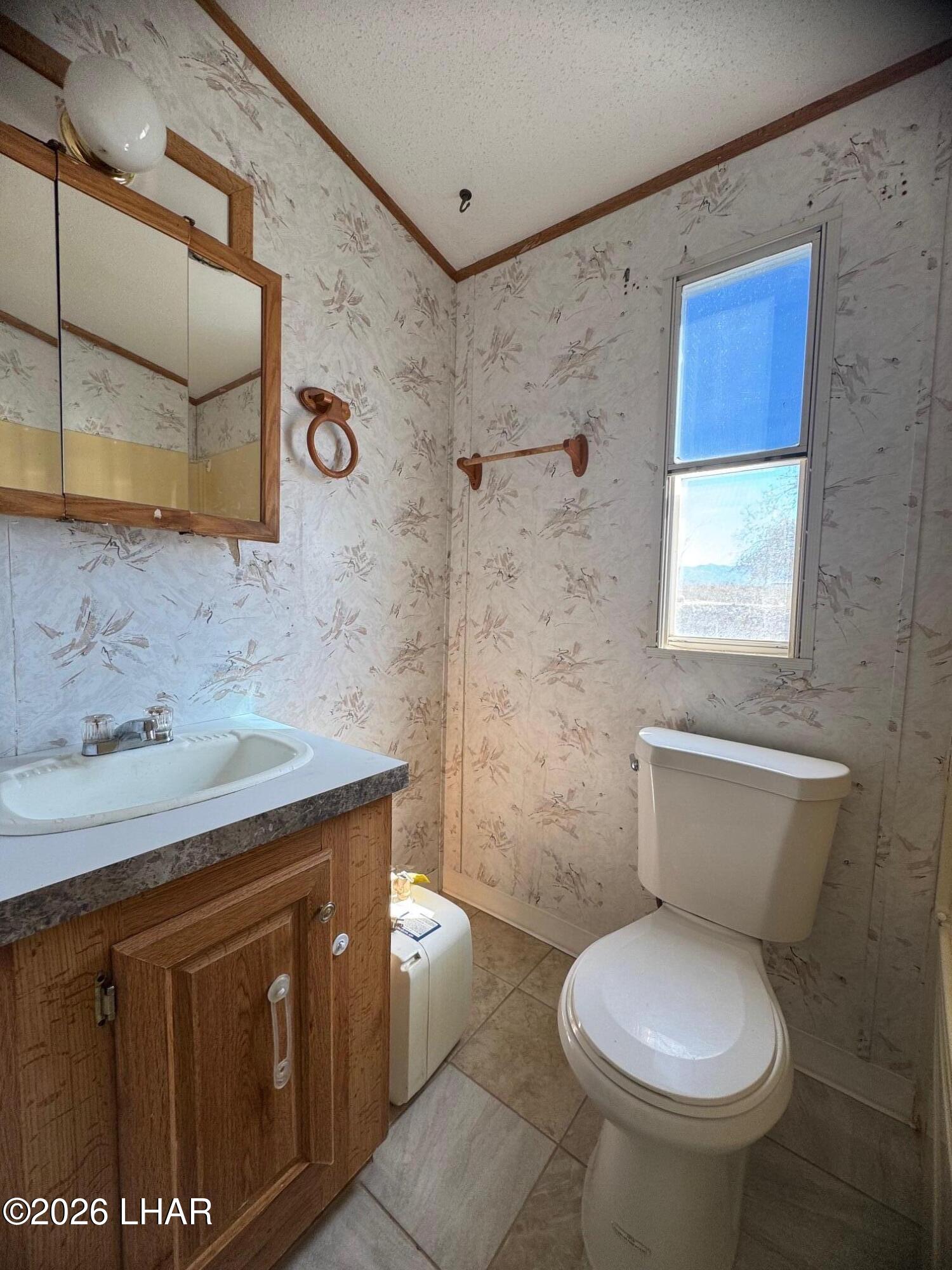 15454 Mohave Road Yucca, AZ 86438 - Photo 24 of 47 a bathroom with a granite countertop toilet sink and mirror