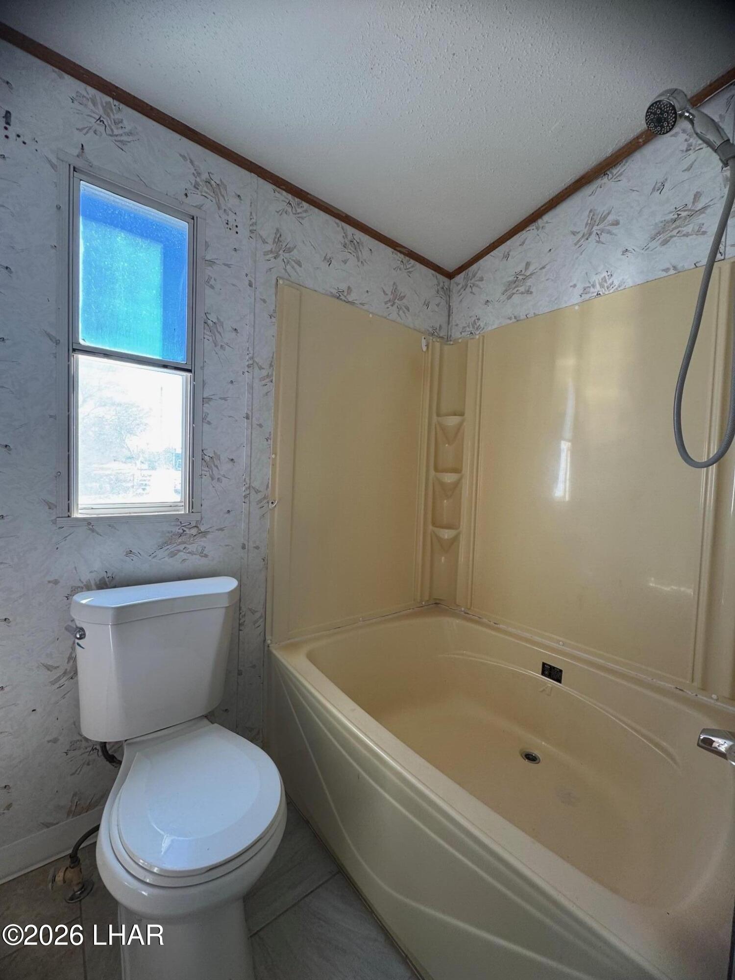 15454 Mohave Road Yucca, AZ 86438 - Photo 26 of 47 a bathroom with a toilet and a shower
