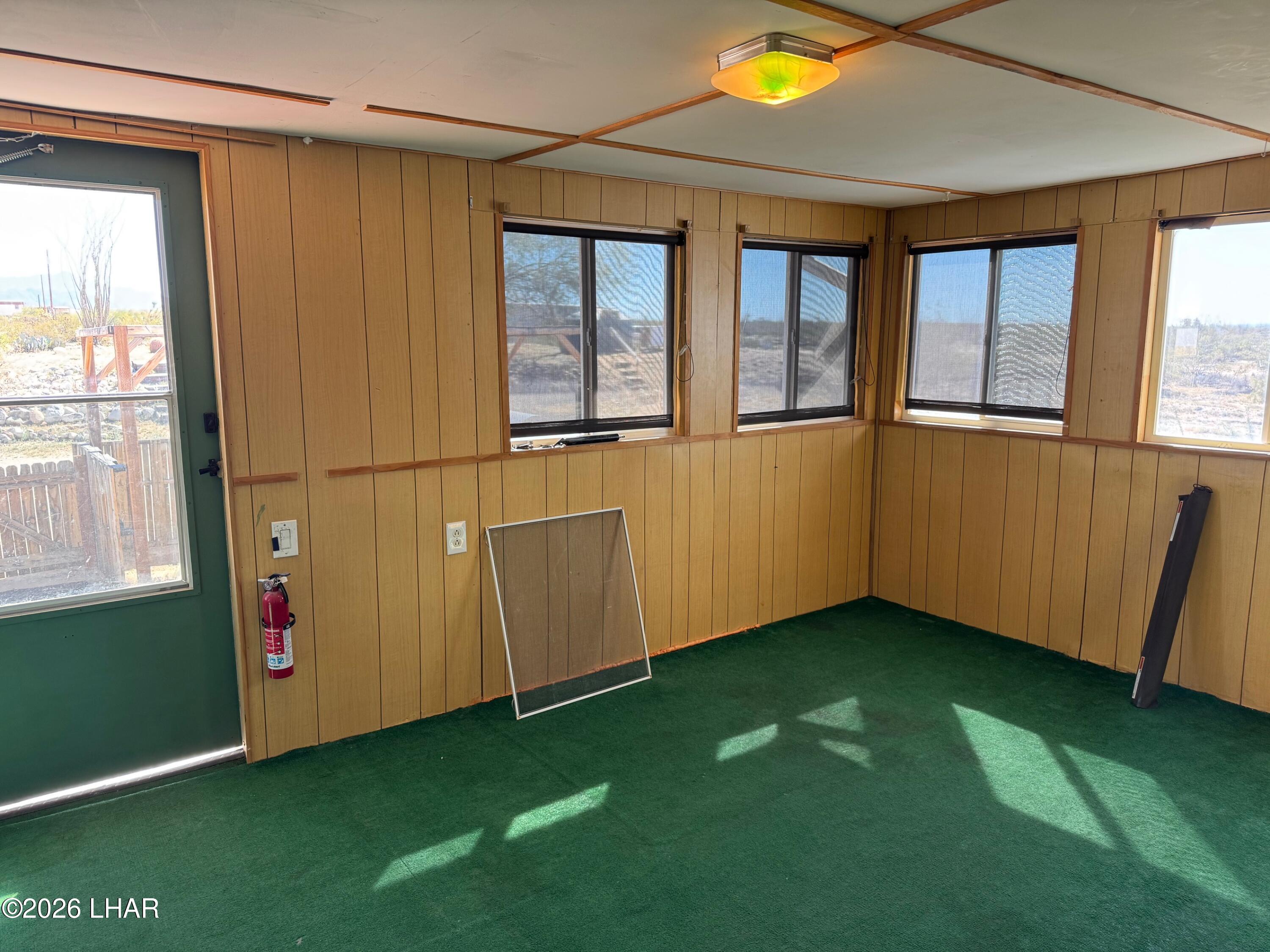 15454 Mohave Road Yucca, AZ 86438 - Photo 28 of 47 a view of an empty room with a window and a kitchen