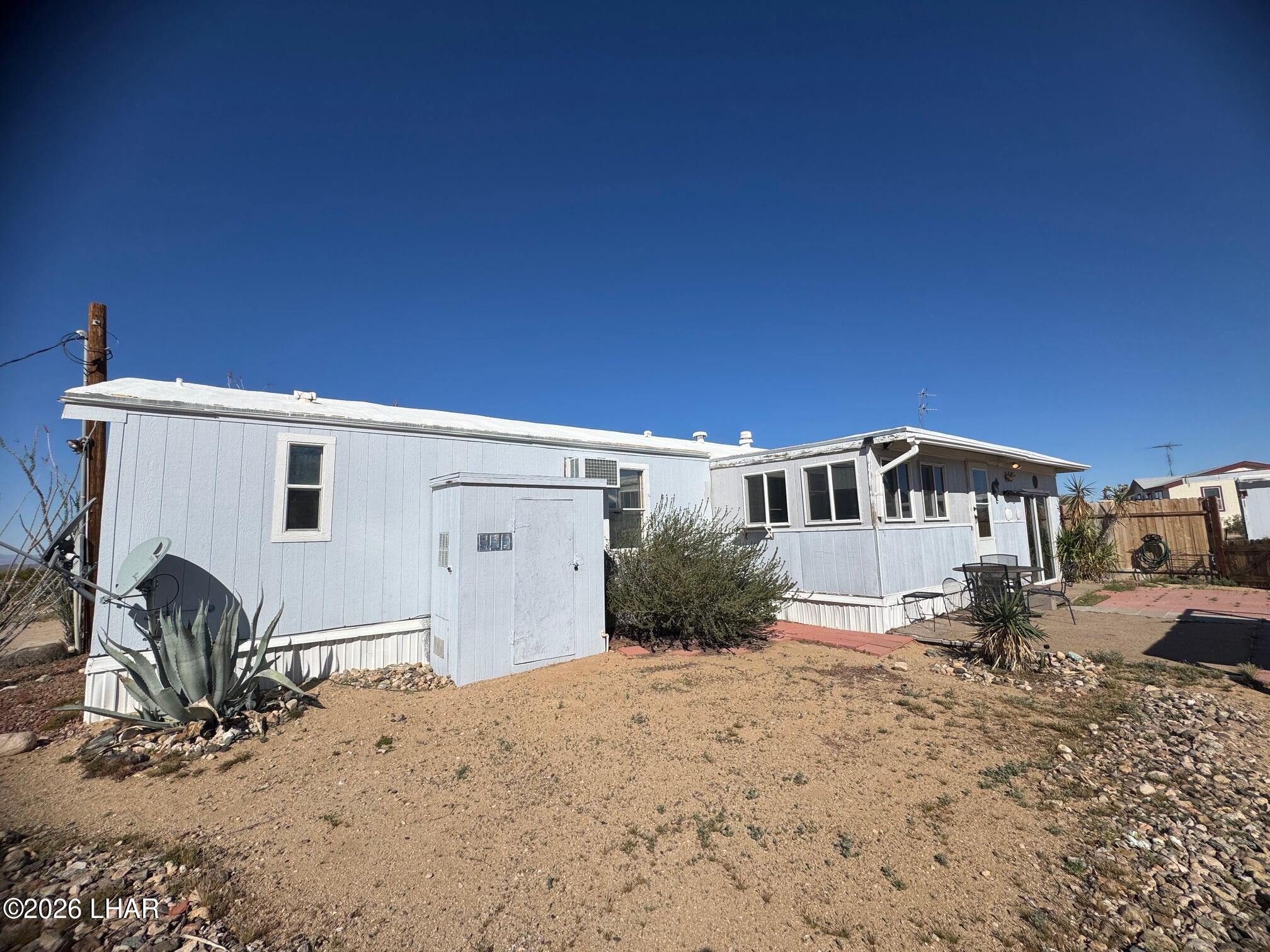 15454 Mohave Road Yucca, AZ 86438 - Photo 31 of 47 a front view of a house with a yard