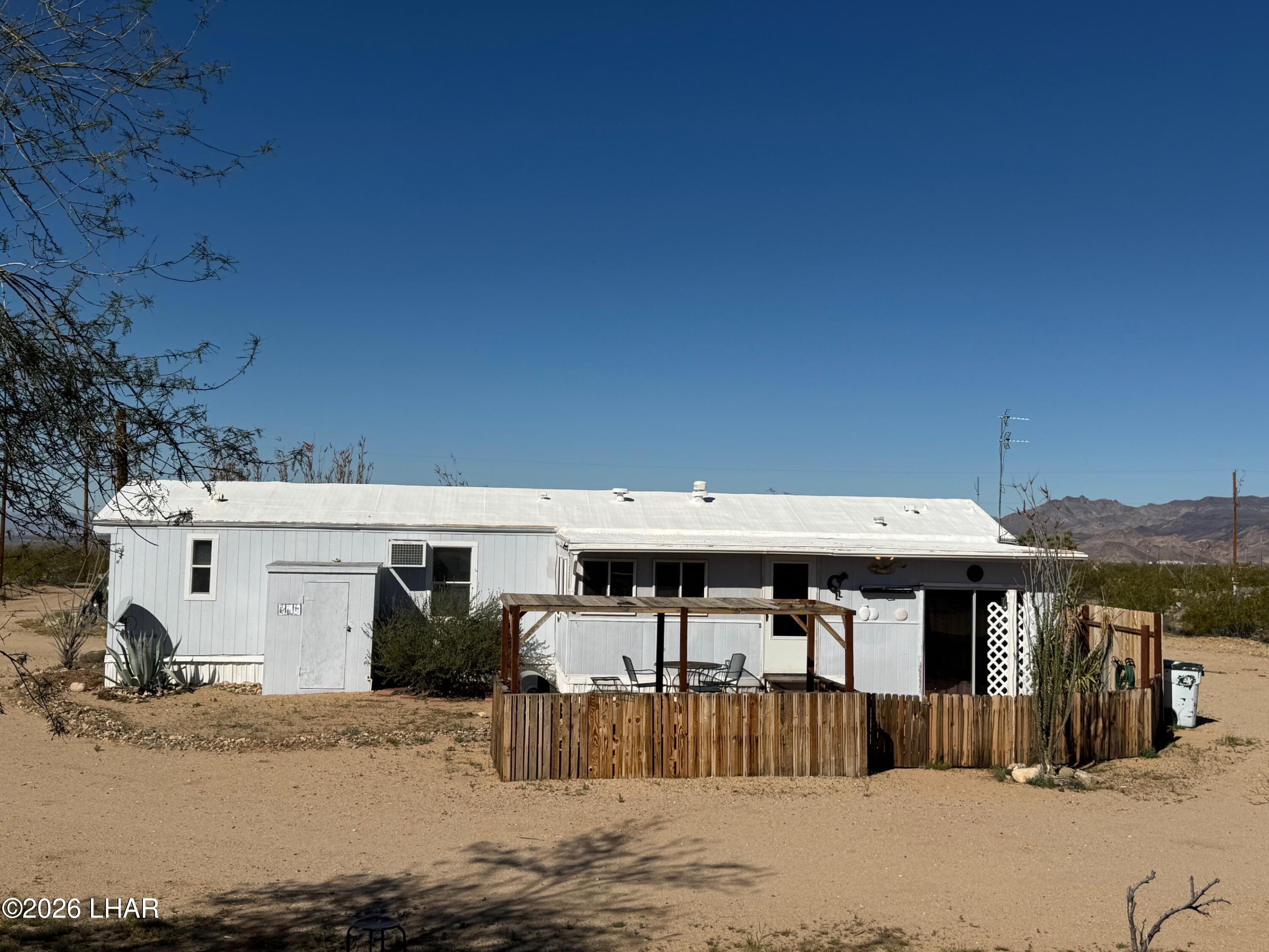 15454 Mohave Road Yucca, AZ 86438 - Photo 32 of 47 a view of a house with backyard
