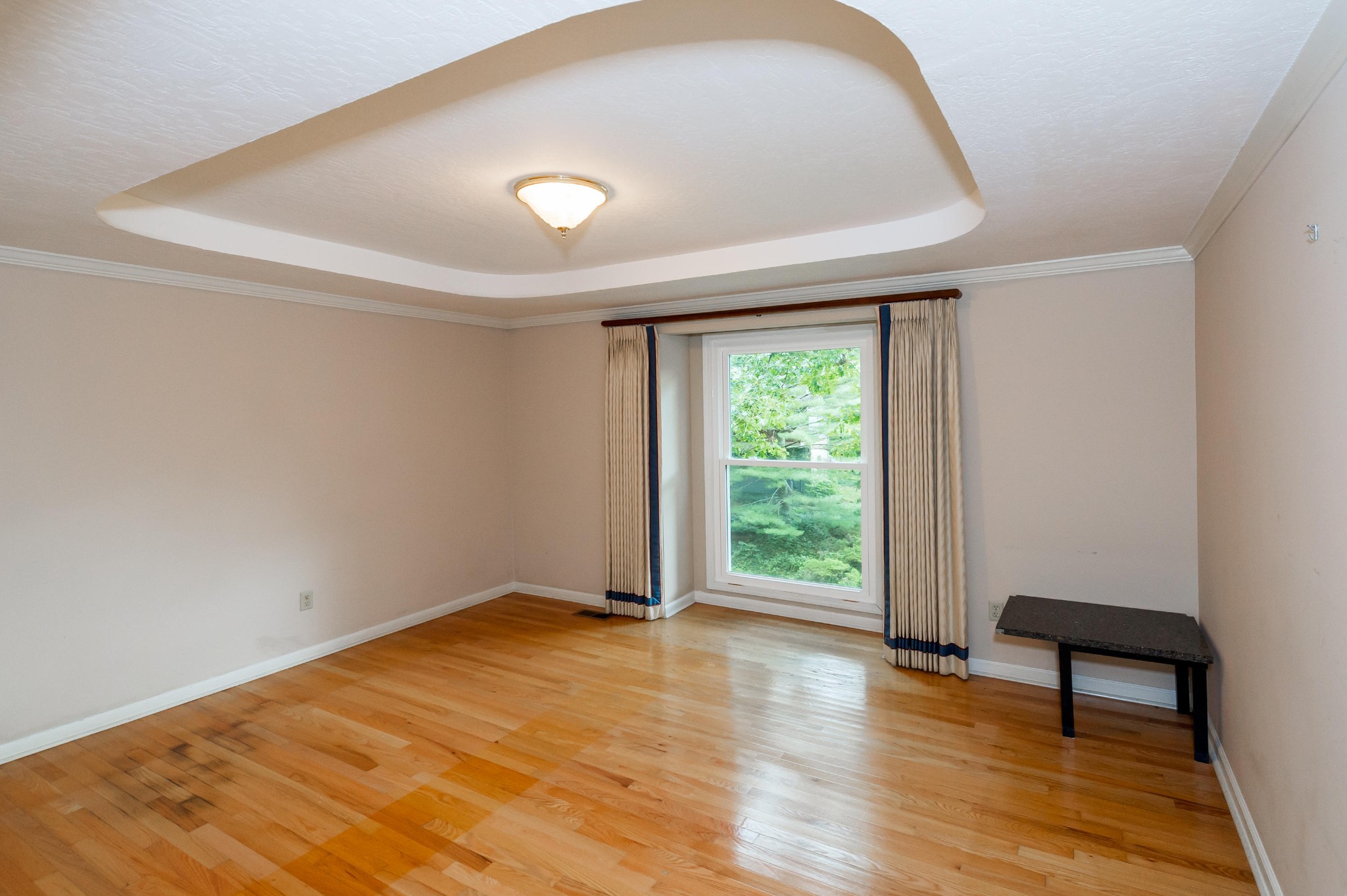 102 Clayton Way Oak Ridge, TN 37830 - Photo 18 of 40 a view of an empty room with wooden floor and a window