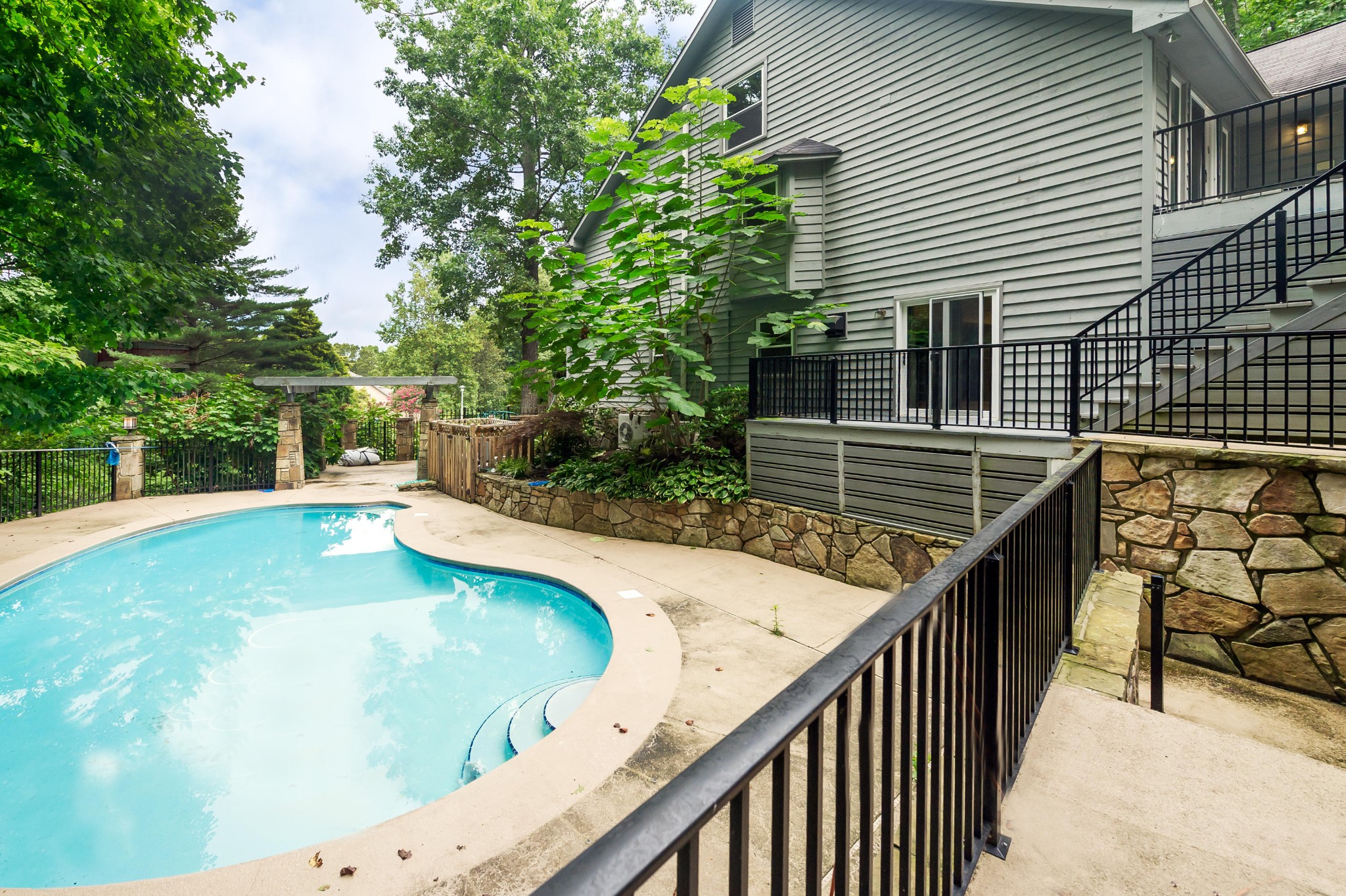 102 Clayton Way Oak Ridge, TN 37830 - Photo 31 of 40 a view of a balcony with two plants and a fire pit