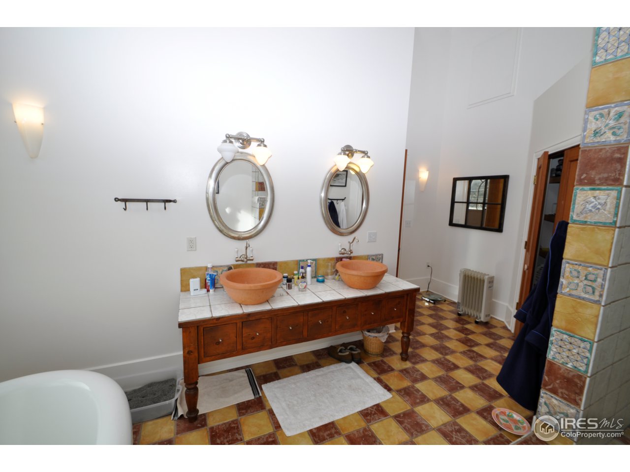 1689 County Road 83 Boulder, CO 80302 - Photo 11 of 17 a living room with furniture a rug and a wall painting
