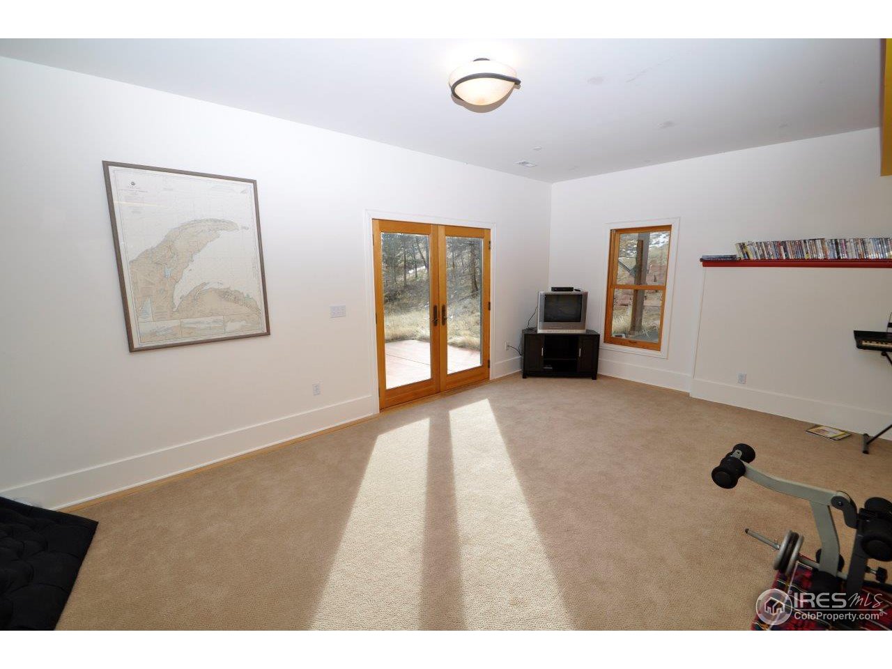 1689 County Road 83 Boulder, CO 80302 - Photo 8 of 17 a view of an empty room with furniture and a window