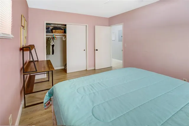 a bedroom with a bed and a closet