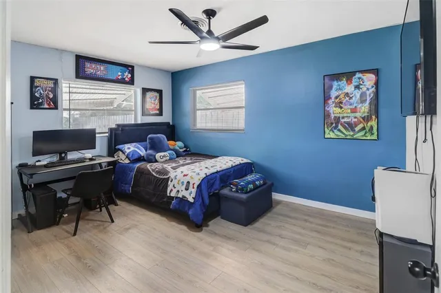 a bedroom with a bed and a desk