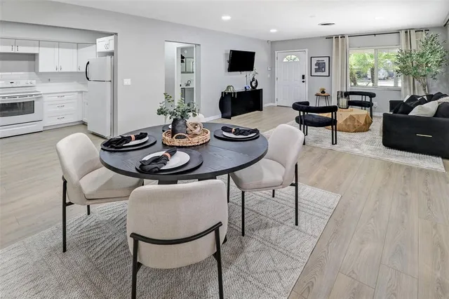 a living room with fireplace furniture and a large window