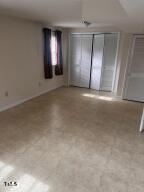 1517 Westchester Road Raleigh, NC 27610 - Photo 7 of 13 an empty room with a empty space and windows