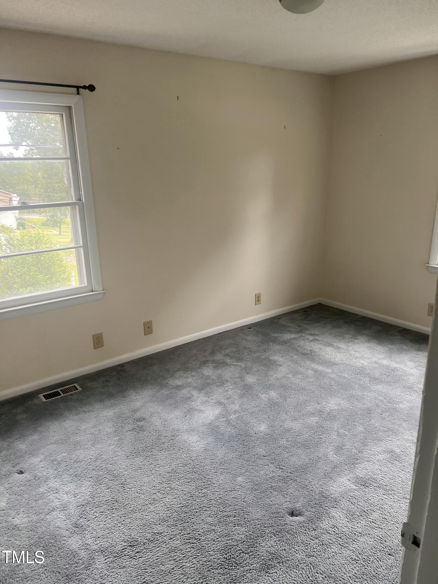 1517 Westchester Road Raleigh, NC 27610 - Photo 9 of 13 an empty room with a window