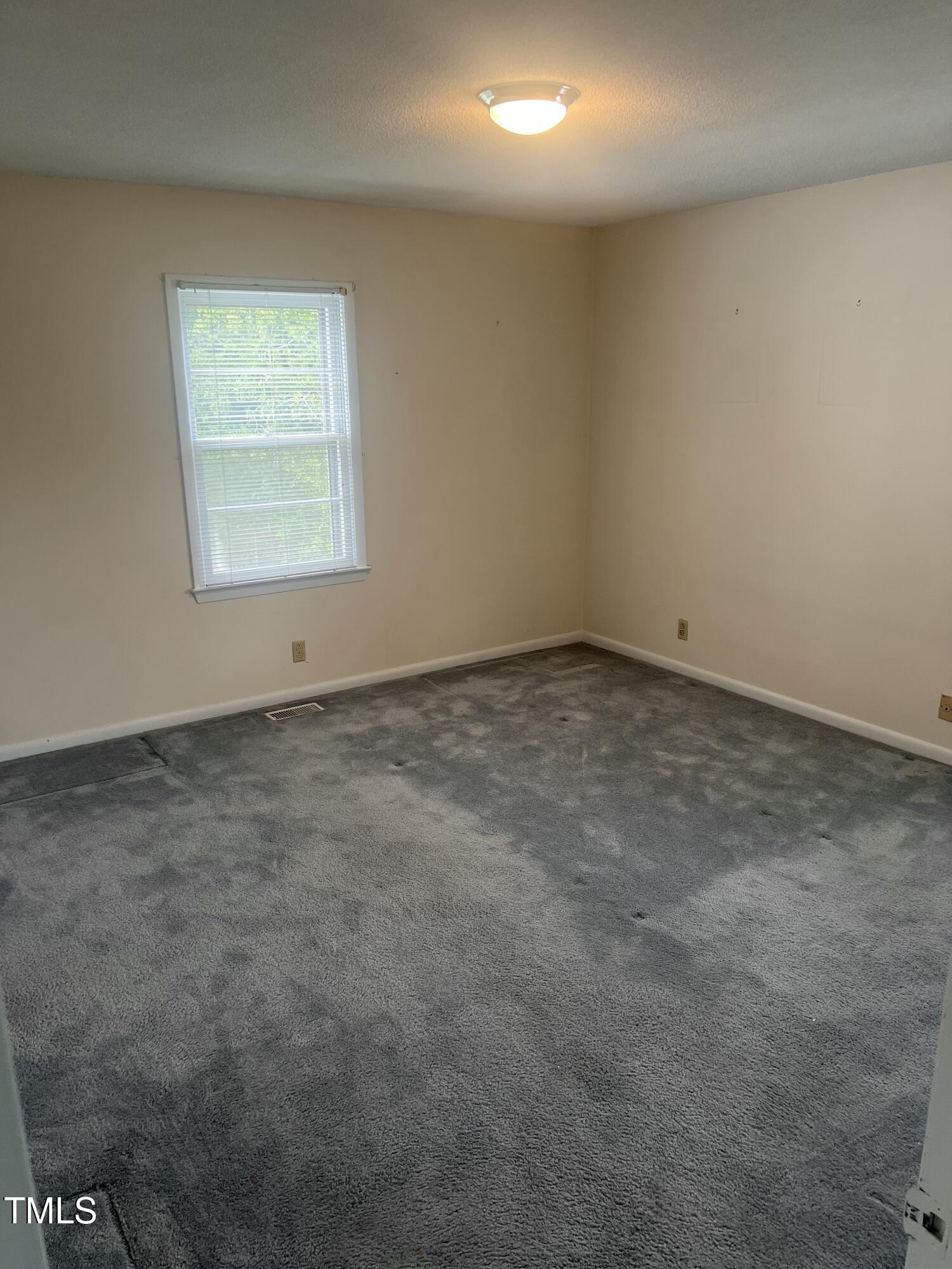 1517 Westchester Road Raleigh, NC 27610 - Photo 10 of 13 an empty room with a window