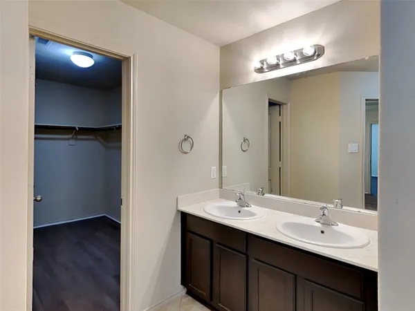 a bathroom with a double vanity sink a and mirror