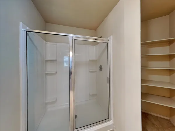 a bathroom with a glass shower door