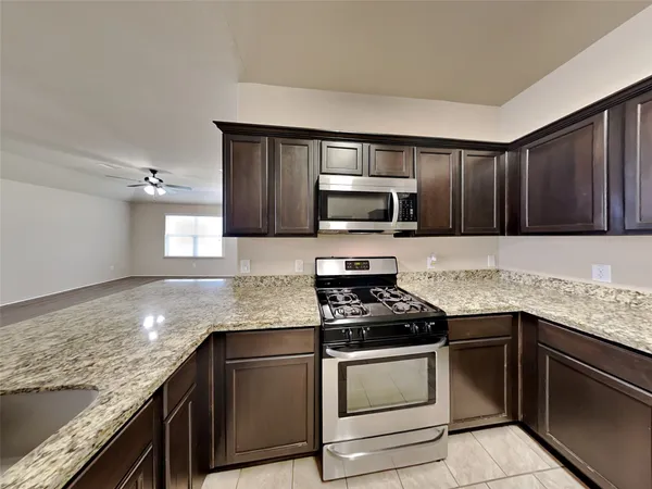 a kitchen with granite countertop stainless steel appliances and cabinets
