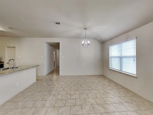 a view of a kitchen with a sink and a window