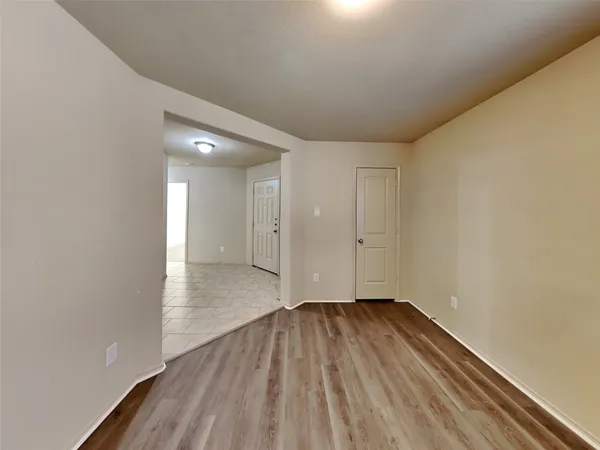 a view of an empty room and wooden floor