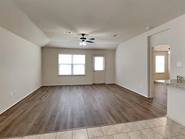 wooden floor in an empty room with a window